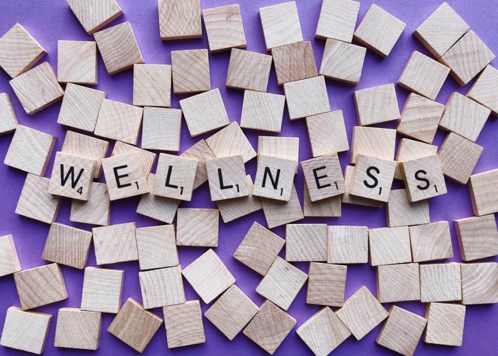 A photo of scrabble letters spelling out the word wellness.