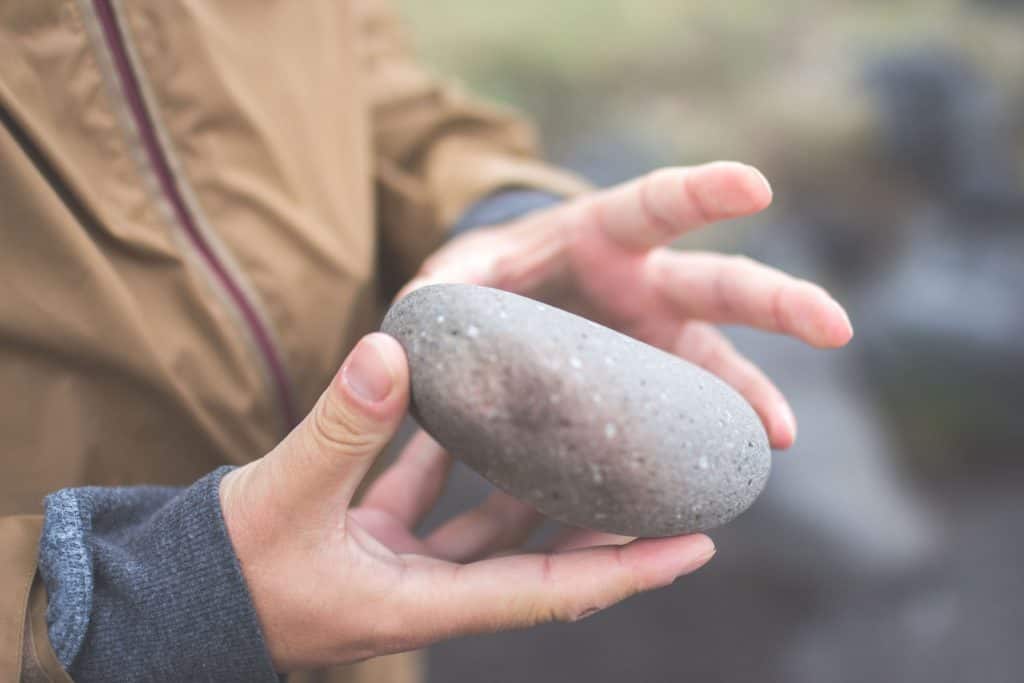 An image of a man holding a stone using his clairtangency.