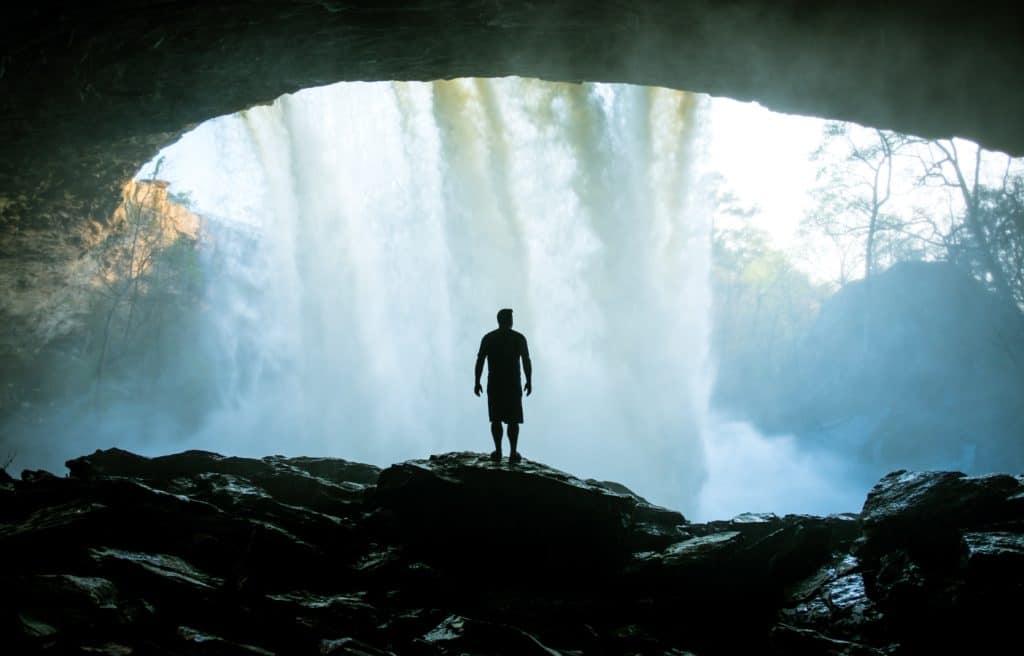 An image of a man standing in a cave.