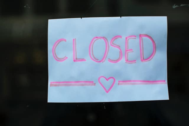 Am image of a sign with a heart on it and the word closed.