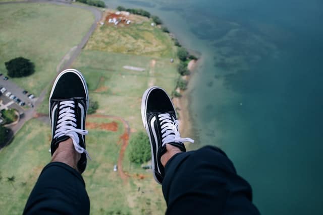 An image of a persons feet high above land.