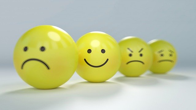 An image of smiley face balls with emotions from happy to sad.